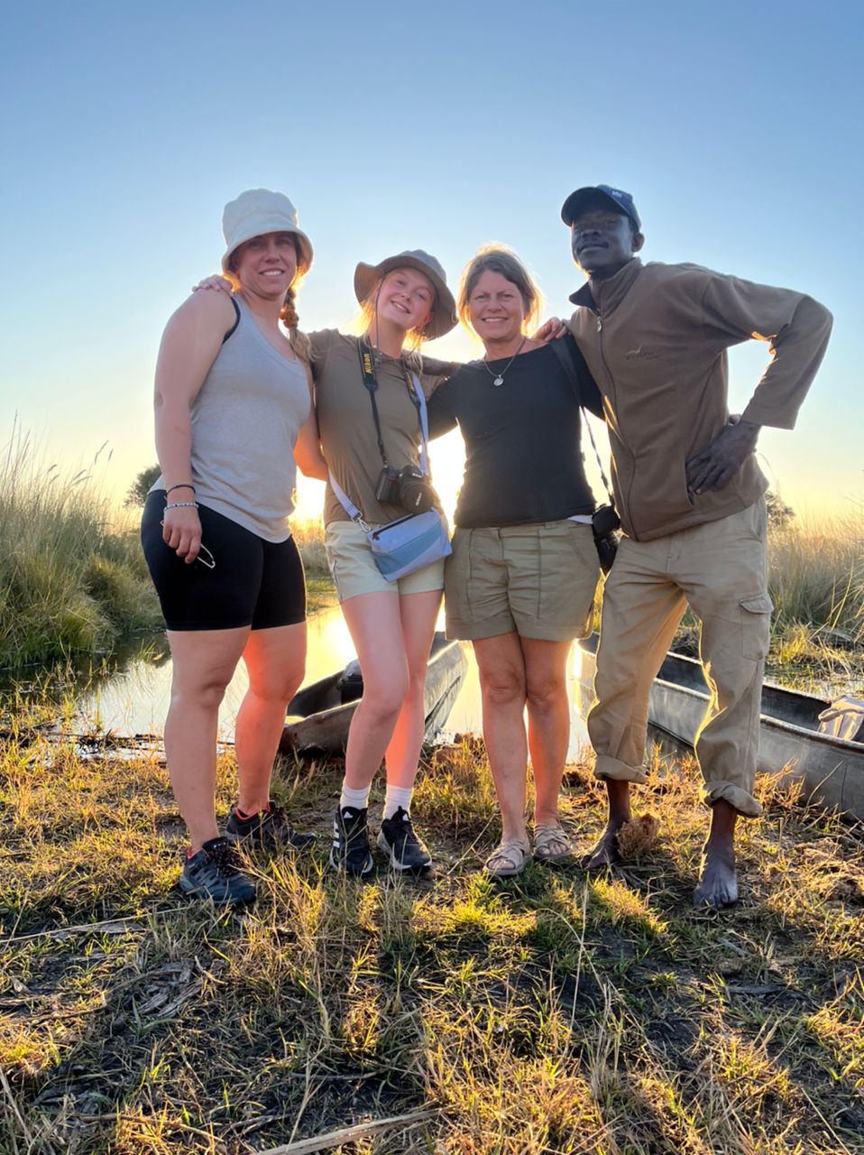 Safari Addicts guests with a local mokoro poler in the Okavango Delta