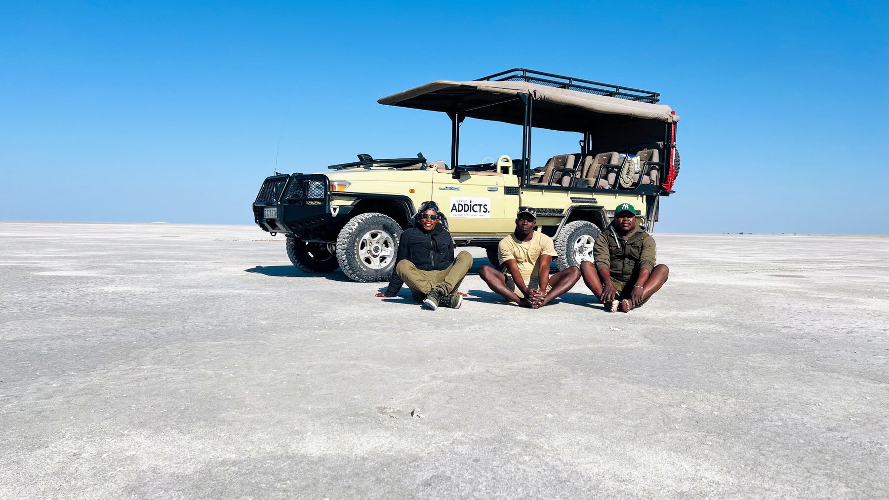 Safari Addicts professional safari guides beside their safari vehicle on Botswana's salt pans